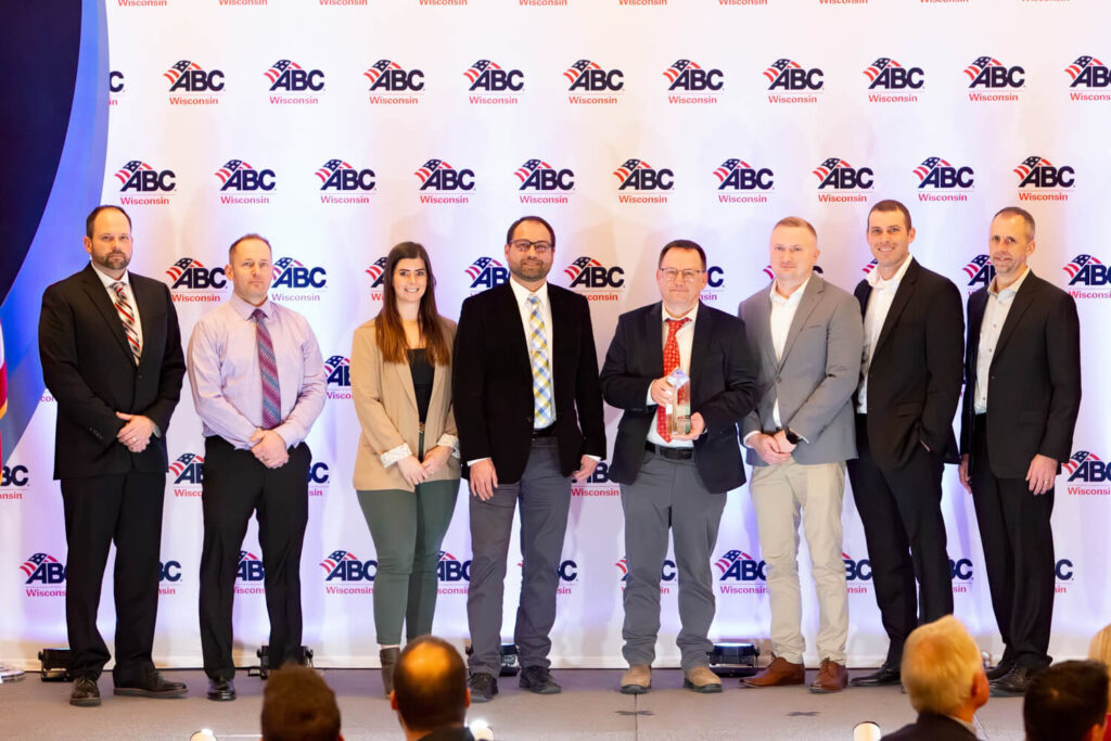 Photo of Faith Technologies Incorporated (FTI), Thermo Fisher Scientific and J.H. Findorff & Son Inc. receiving the gold-level 2024 Projects of Distinction Award from the Associated Builders and Contractors (ABC) of Wisconsin. Pictured from left to right: Aaron Bizub, FTI; Ryan Will, FTI; Jenna Gruter, J.H. Findorff & Son Inc.; Joseph Liesner, Strang, Inc.; Alex Jushchyshyn, Thermo Fisher Scientific; Brady Deruchowski, FTI; Joe Jungbauer, FTI; Wade Liepold, FTI.