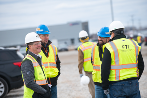 Pictured left, Mike Jansen, CEO of Faith Technologies Incorporated (FTI), talking with FTI team members on a jobsite.